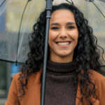 Woman smiling in the rain in Austell and [test_shortcode]