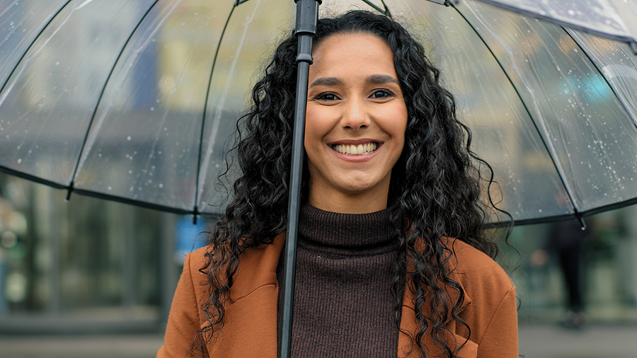 Woman smiling in the rain in Austell and [test_shortcode]